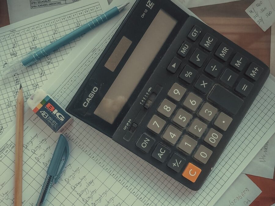 a calculator sitting on top of a pile of papers
